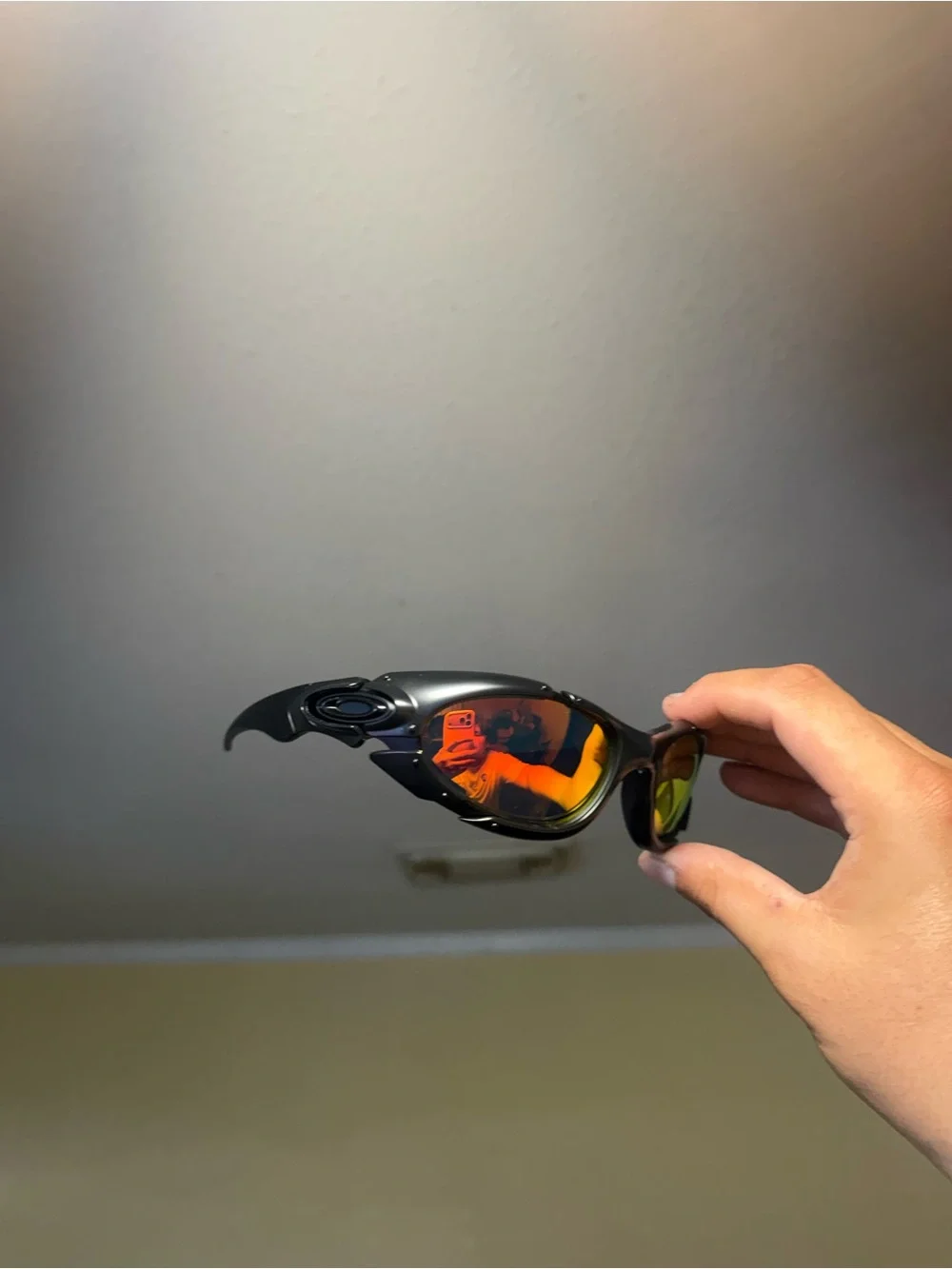 Oakley Black Frame Sunglasses with Orange-Red Mirrored Lenses